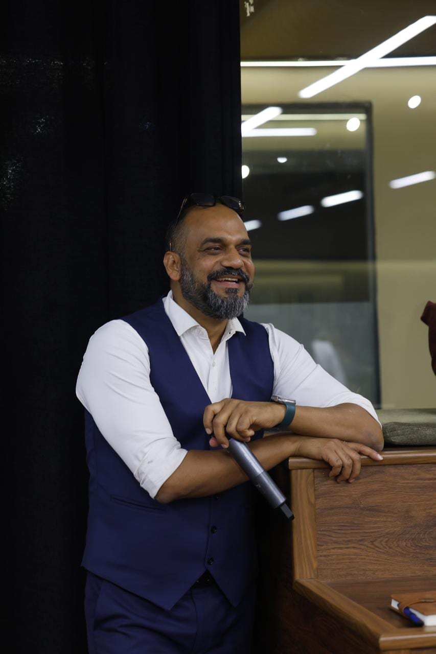 Vijay Sharma — growth architect, smiling with a microphone in hand